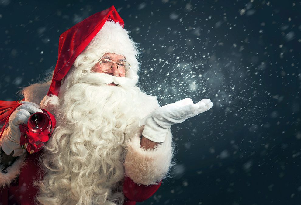 Santa Claus blowing magic snow of his hands